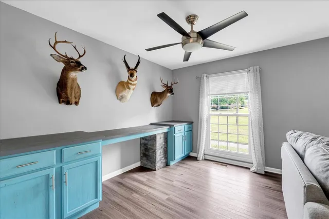 a kitchen with stainless steel appliances granite countertop a stove top oven a sink dishwasher and a microwave oven with white cabinets