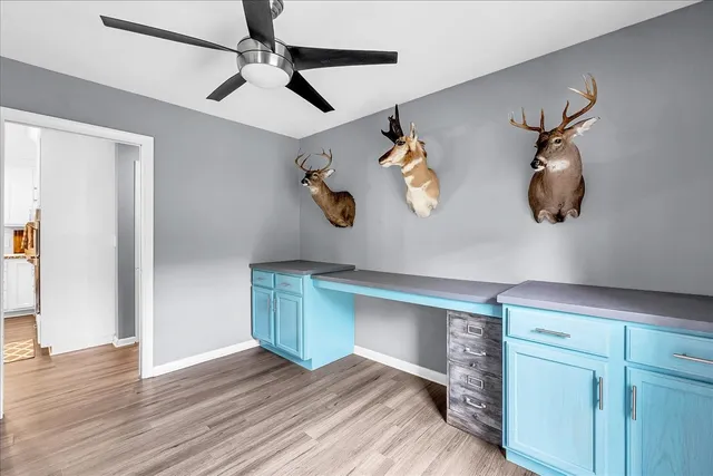 a kitchen with stainless steel appliances granite countertop a stove top oven a sink dishwasher and a microwave oven with white cabinets