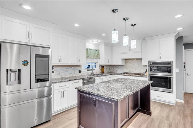 a view of a livingroom with furniture and a fireplace