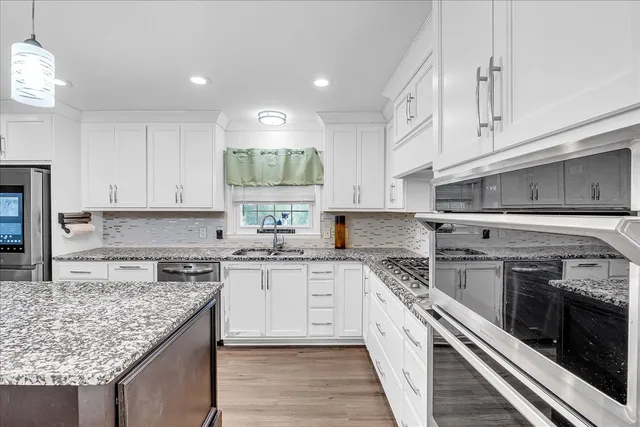 a living room with furniture and a ceiling fan