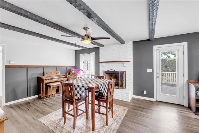 a bedroom with two beds and ceiling fan