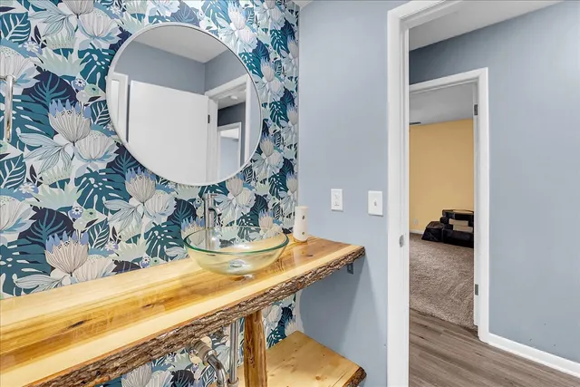 a bathroom with a sink toilet and mirror