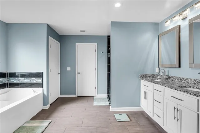 an aerial view of residential houses with outdoor space and trees