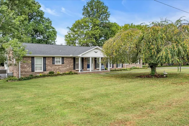 a front view of a house with a garden