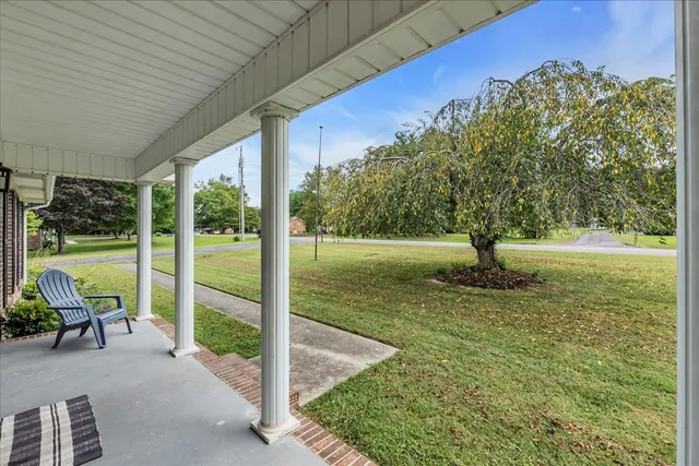 a front view of a house with a yard table and chairs