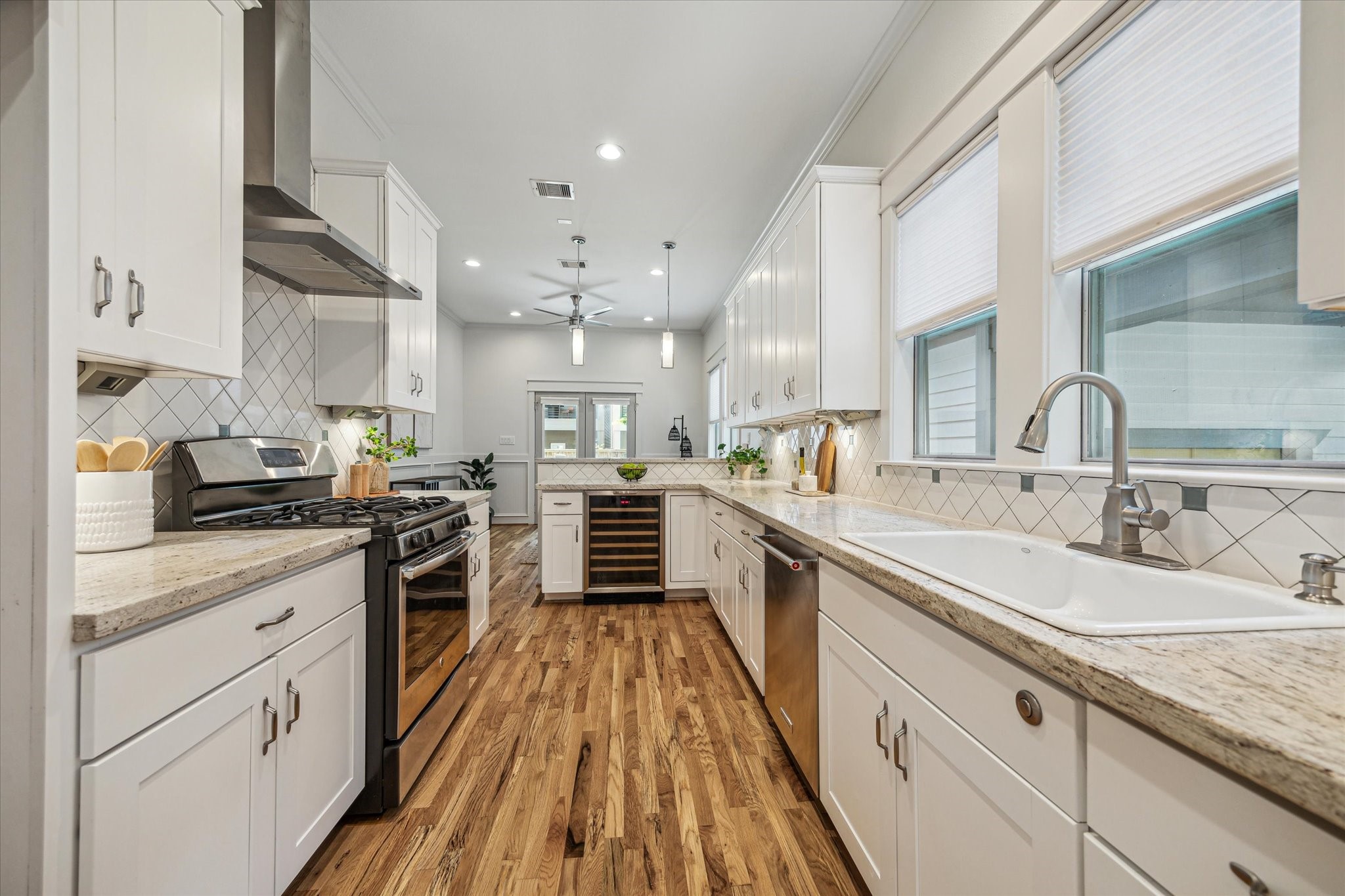 1833 Tabor Street Houston, TX 77009 - Photo 12 of 28 The heart of the home features a wine cooler and is open to the living spaces with views of the front and back.