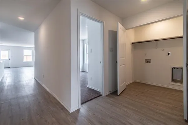 a view of hallway with wooden floor