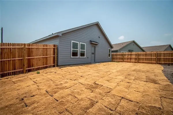 a view of wooden fence and a house