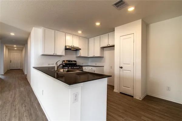 a kitchen with a sink stove and refrigerator