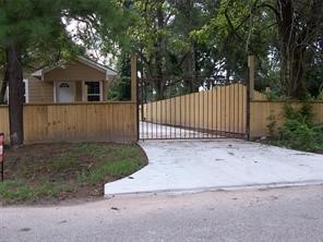 1714 North Travis Avenue Cleveland, TX 77327 - Photo 4 of 8 a white house that has tree in front of it