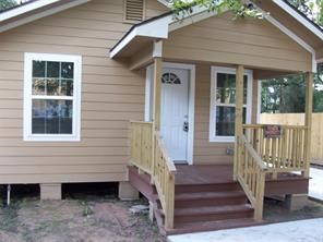 1714 North Travis Avenue Cleveland, TX 77327 - Photo 5 of 8 a view of a house with wooden floor and a window