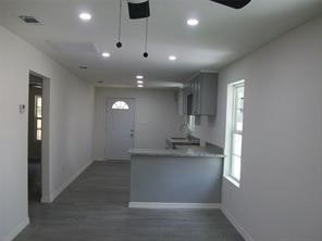 1714 North Travis Avenue Cleveland, TX 77327 - Photo 6 of 8 an empty room with wooden floor and windows