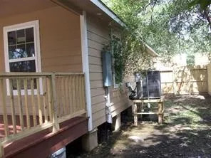 a backyard of a house with table and chairs