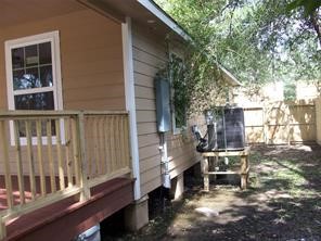 1714 North Travis Avenue Cleveland, TX 77327 - Photo 7 of 8 a backyard of a house with table and chairs