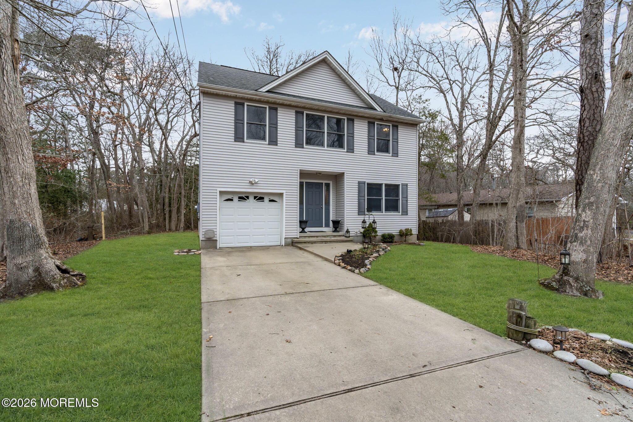 9 Forecastle Way Waretown, NJ 08758 - Photo 47 of 51 a front view of a house with a yard and garage