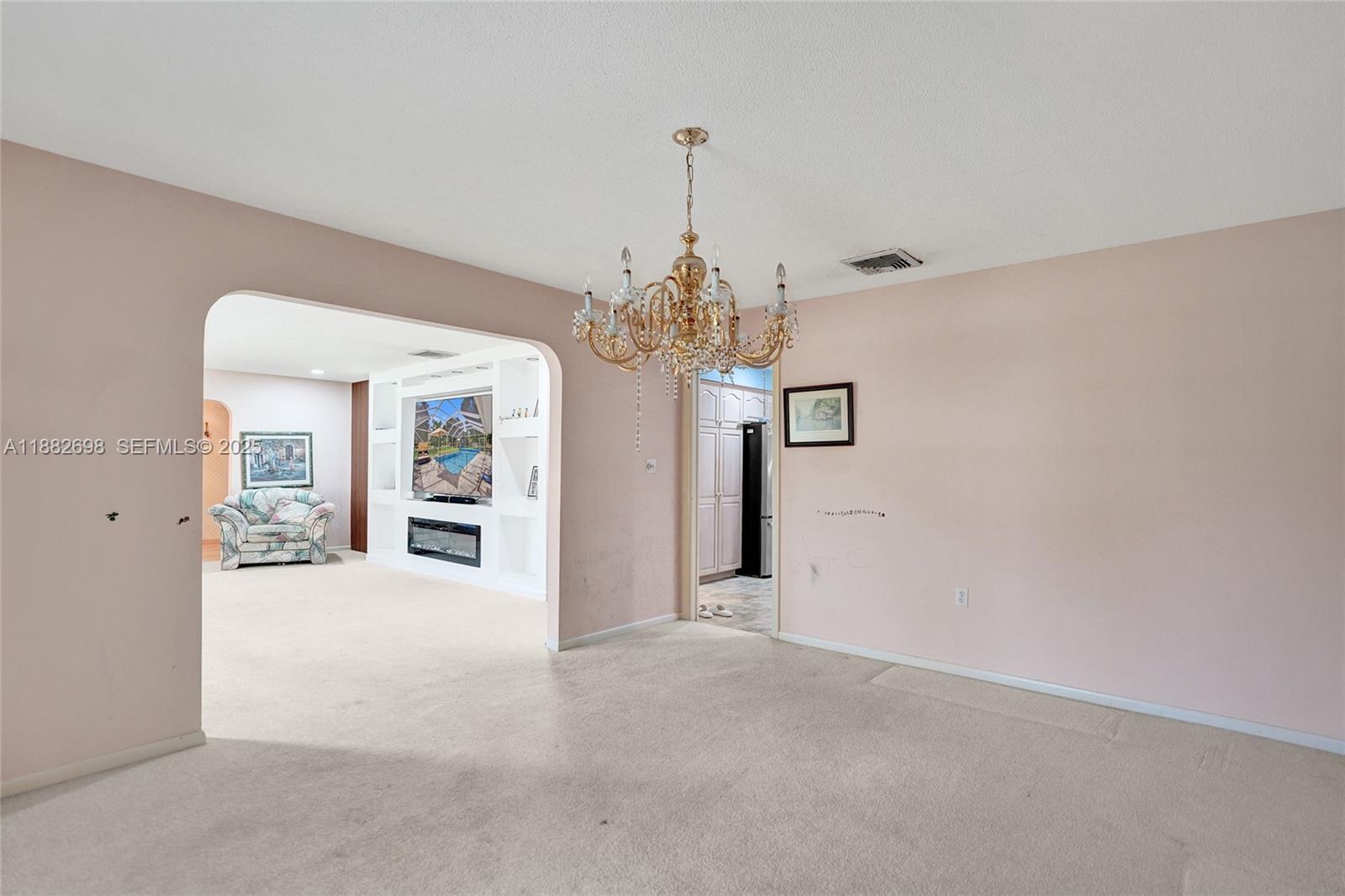 1021 Grandview Boulevard Fort Pierce, FL 34982 - Photo 14 of 34 a view of a chandelier in a room