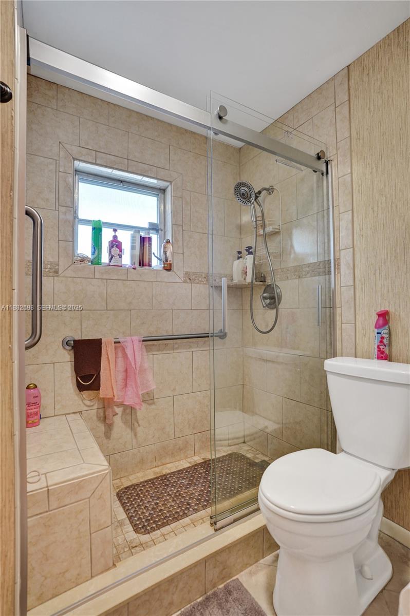 1021 Grandview Boulevard Fort Pierce, FL 34982 - Photo 18 of 34 a bathroom with a sink a toilet and shower