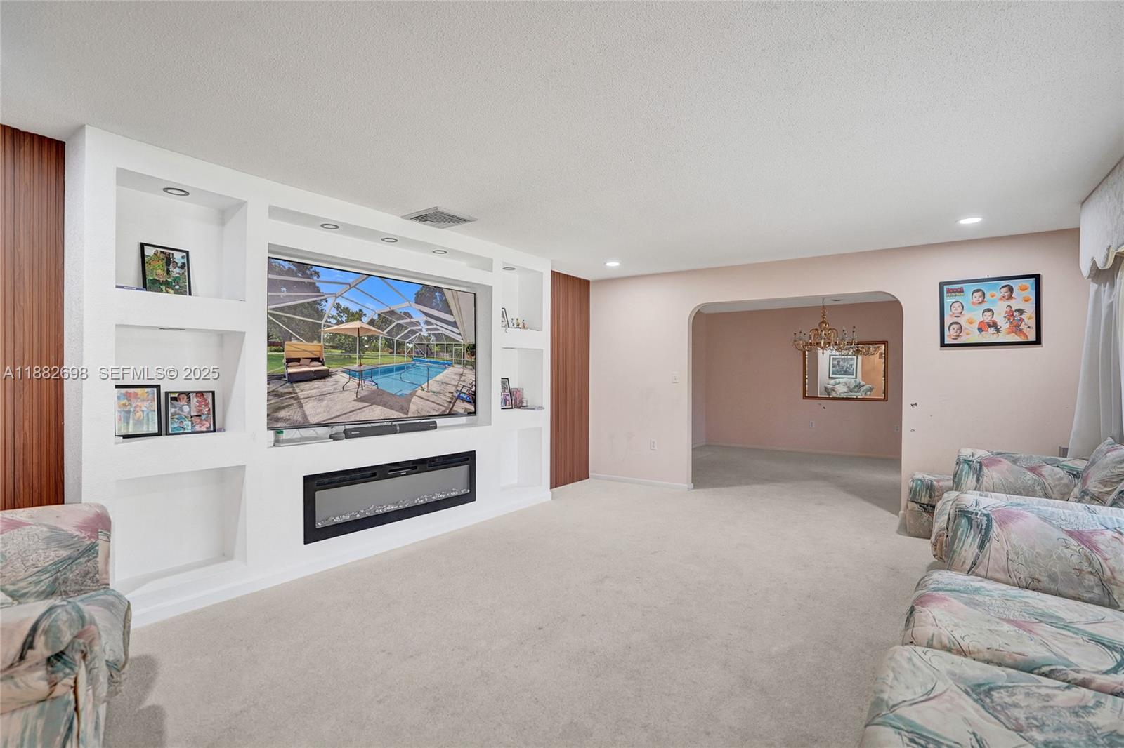 1021 Grandview Boulevard Fort Pierce, FL 34982 - Photo 4 of 34 a living room with furniture and a flat screen tv