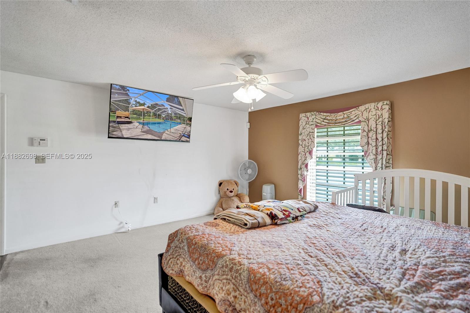 1021 Grandview Boulevard Fort Pierce, FL 34982 - Photo 7 of 34 a bedroom with a bed and a window