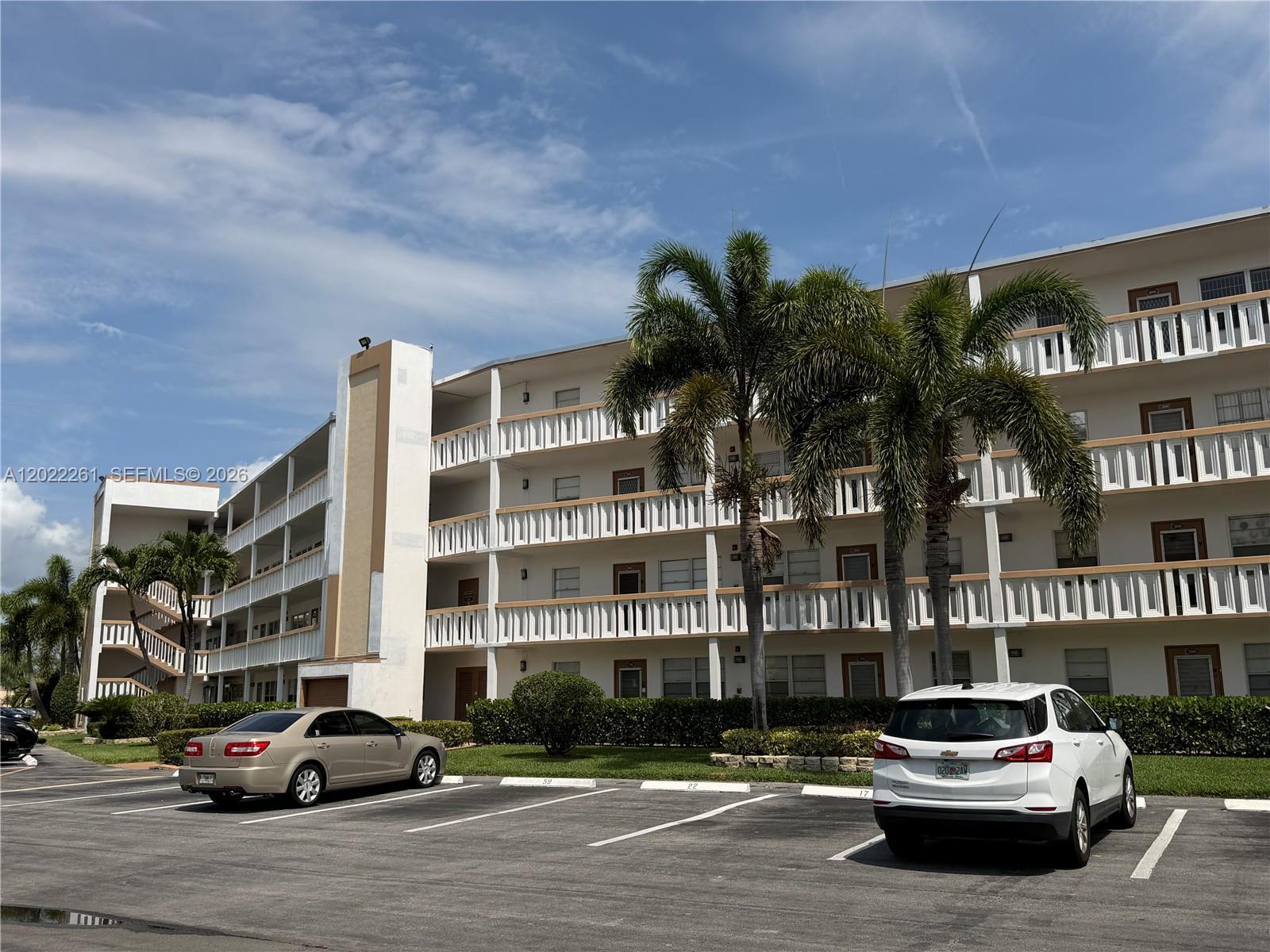 4043 Cornwall C, Unit 4043 Boca Raton, FL 33434 - Photo 1 of 16 a car parked in front of a building
