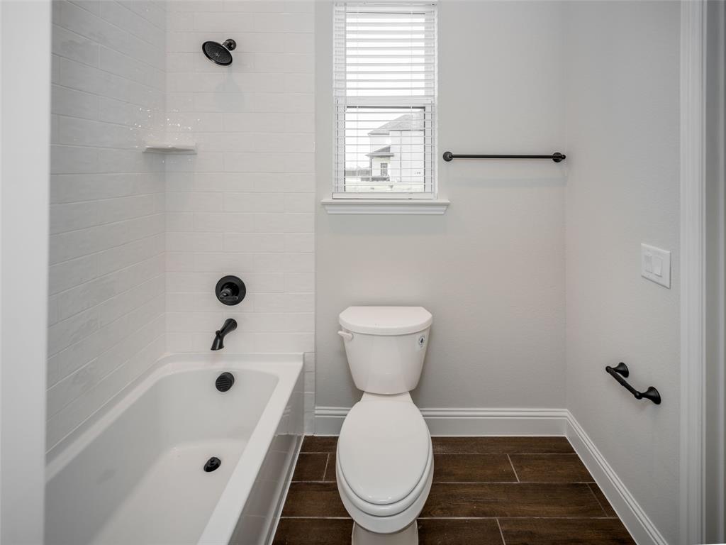 2108 Charters Circle Nevada, TX 75173 - Photo 29 of 37 Full bathroom featuring shower / bath combination and wood finish floors