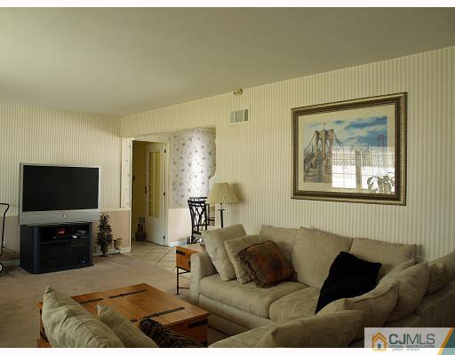 24 Harding Avenue Edison, NJ 08820 - Photo 3 of 10 a living room with furniture and a flat screen tv