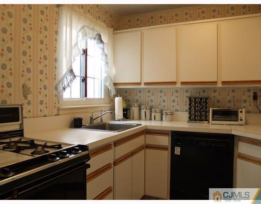 24 Harding Avenue Edison, NJ 08820 - Photo 4 of 10 a kitchen with stainless steel appliances a sink a stove and a microwave