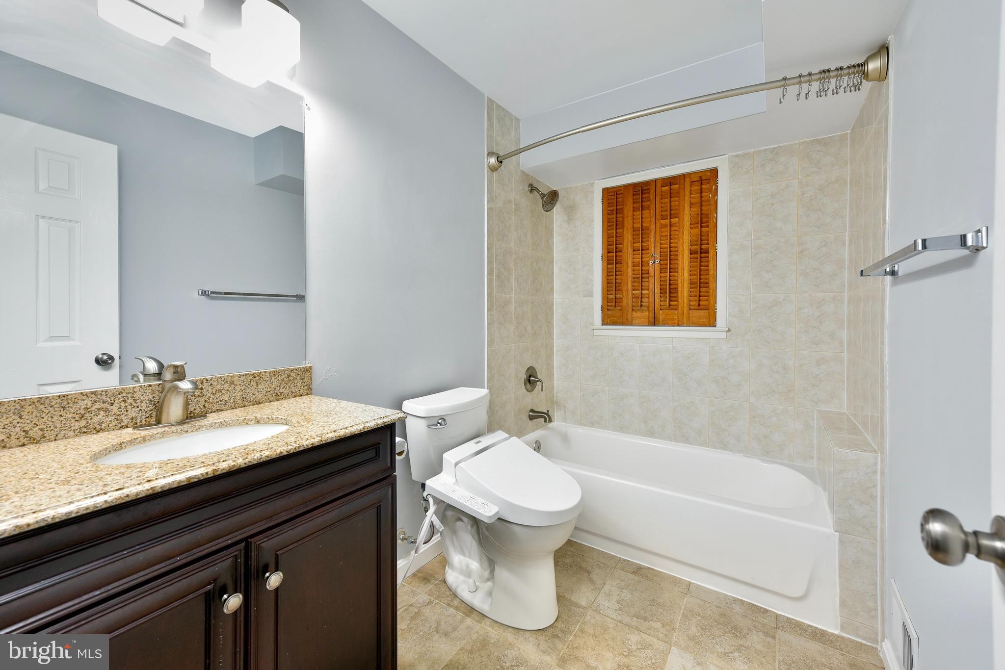 5012 Dodson Drive Annandale, VA 22003 - Photo 25 of 44 a bathroom with a granite countertop sink toilet and shower
