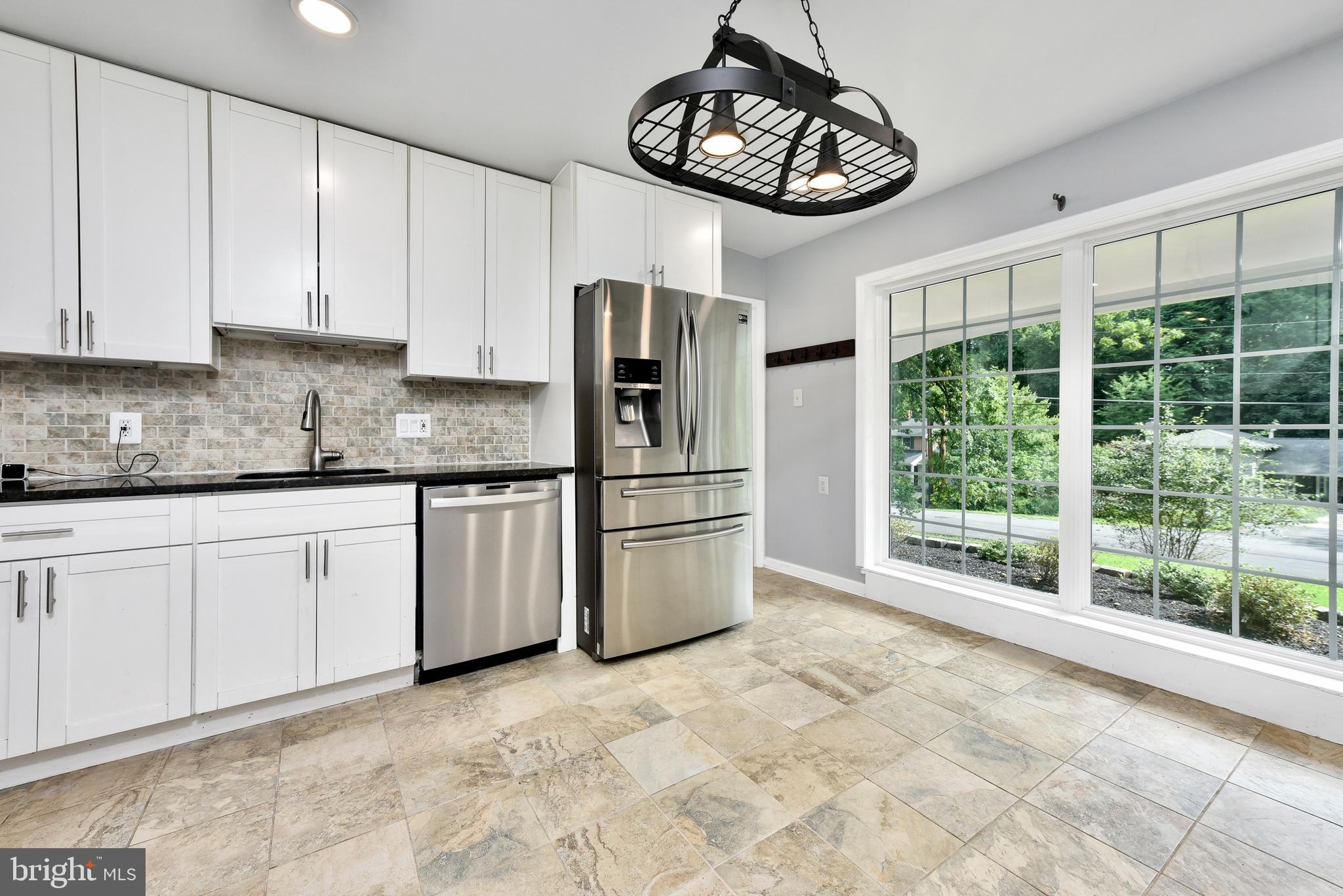 5012 Dodson Drive Annandale, VA 22003 - Photo 10 of 44 a kitchen with stainless steel appliances granite countertop a stove a refrigerator and a granite counter tops