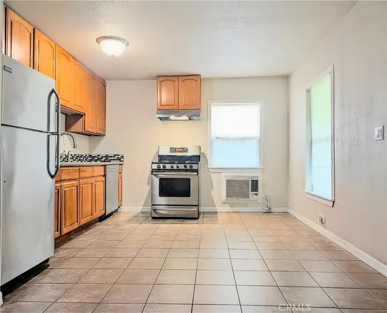 a kitchen with stainless steel appliances a stove a sink and a refrigerator