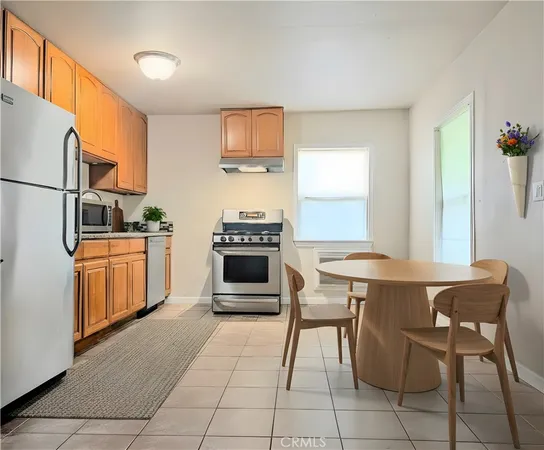 a kitchen with appliances cabinets and furniture