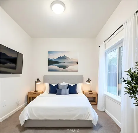a bedroom with a large bed and a tv