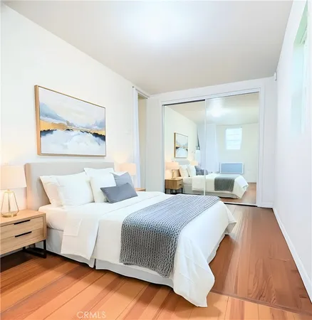 a bedroom with a bed and a night stand