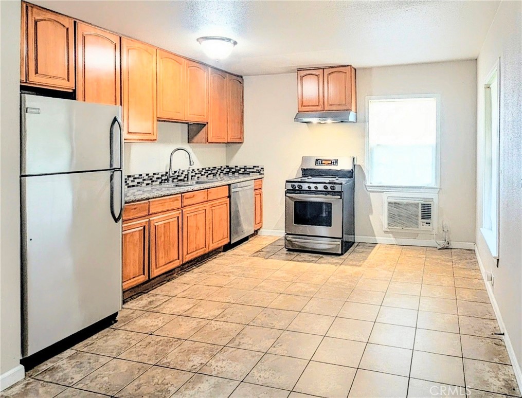363 Ford Road Sacramento, CA 95838 - Photo 10 of 23 a kitchen with stainless steel appliances granite countertop a stove top oven a sink a microwave and a refrigerator