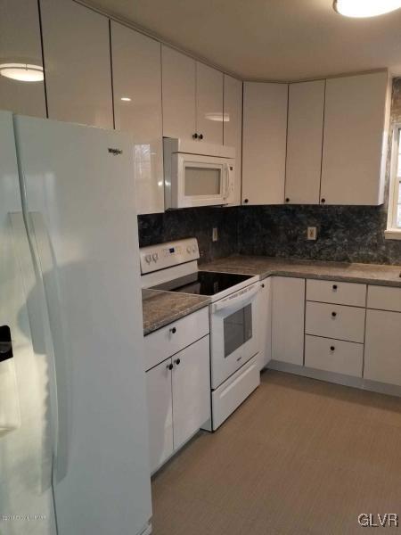 134 Ryan Road Blakeslee, PA 18610 - Photo 6 of 33 a kitchen with white cabinets and white appliances