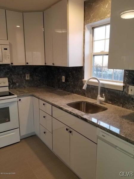 134 Ryan Road Blakeslee, PA 18610 - Photo 8 of 33 a kitchen with granite countertop white cabinets and white appliances