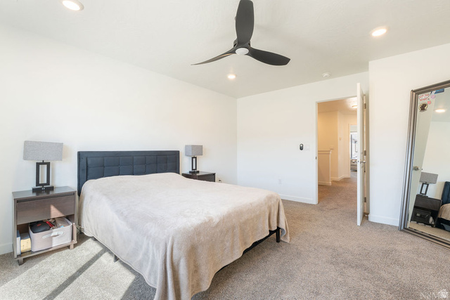 1693 Devils Gdn Lane Washington, UT 84780 - Photo 25 of 64 Spacious bedroom featuring neutral carpeting, recessed lighting, and a modern ceiling fan