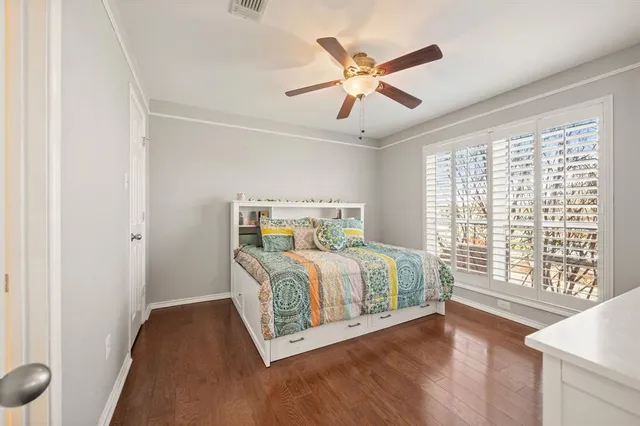 a bedroom with a large bed and a large window