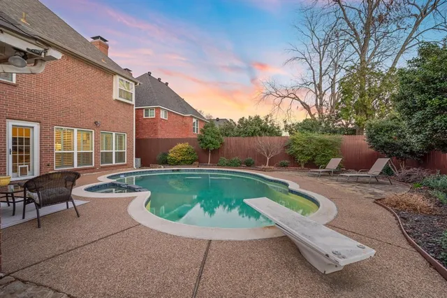a view of swimming pool with outdoor seating and plants