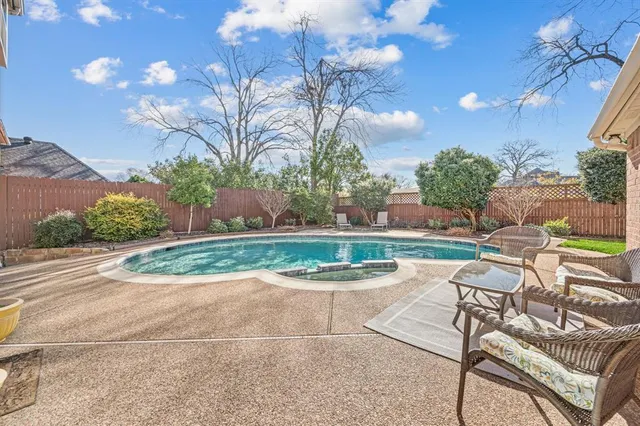 a white bench sitting in middle of a yard