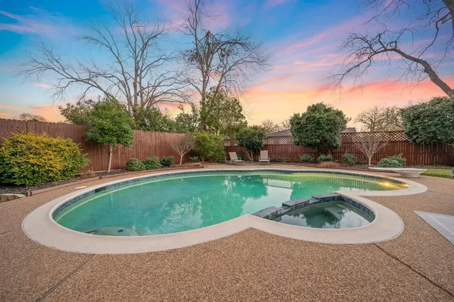 a view of a swimming pool with a yard