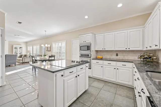 a kitchen with white cabinets appliances and a sink