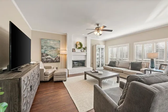 a living room with furniture flat screen tv and large window