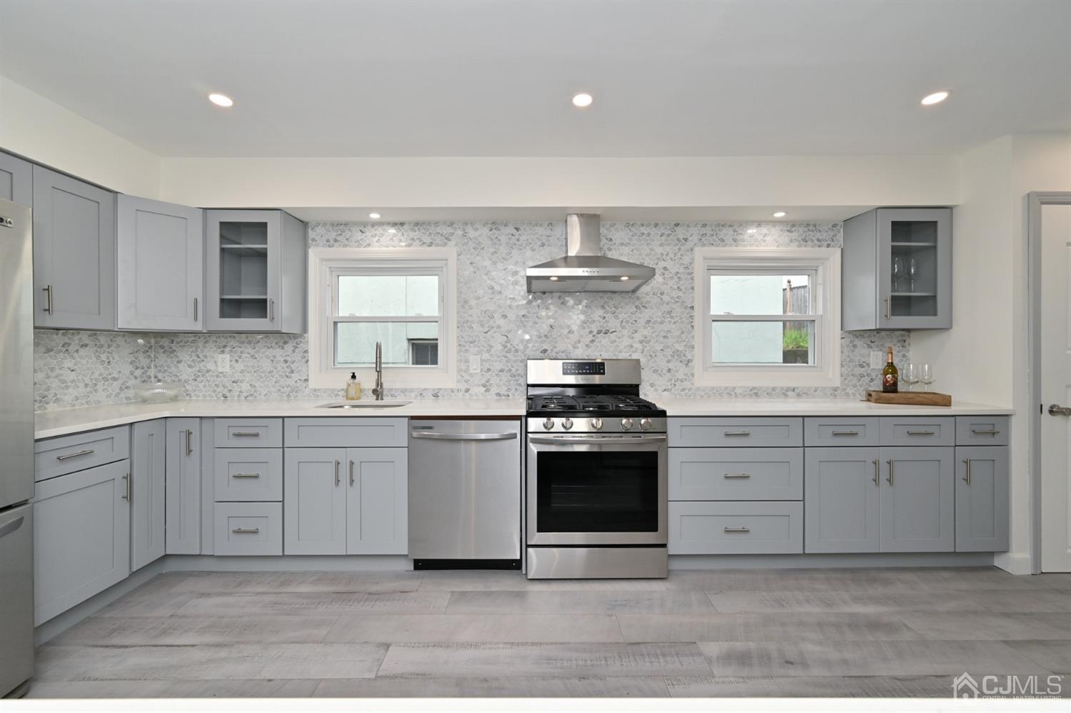 383 Paterson Avenue East Rutherford, NJ 07073 - Photo 2 of 21 a kitchen with stainless steel appliances granite countertop a stove a sink and a refrigerator