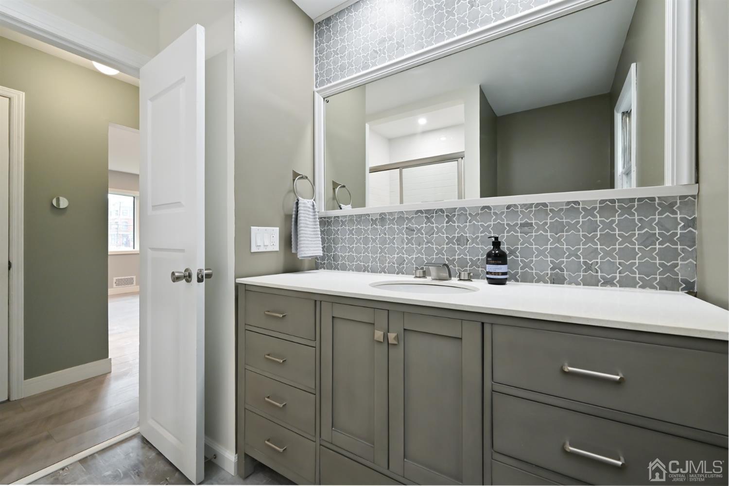 383 Paterson Avenue East Rutherford, NJ 07073 - Photo 13 of 21 a bathroom with a double vanity sink and mirror