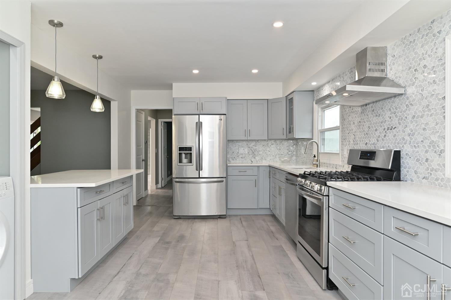 383 Paterson Avenue East Rutherford, NJ 07073 - Photo 14 of 21 a kitchen with a sink a refrigerator and a stove