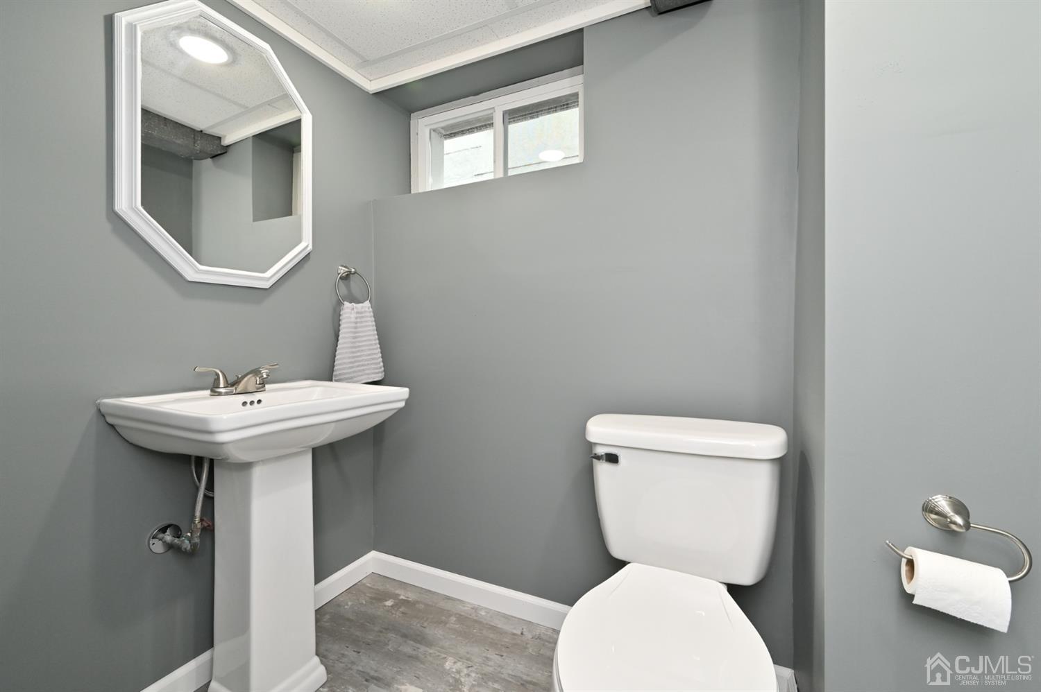 383 Paterson Avenue East Rutherford, NJ 07073 - Photo 17 of 21 a bathroom with a toilet sink and mirror
