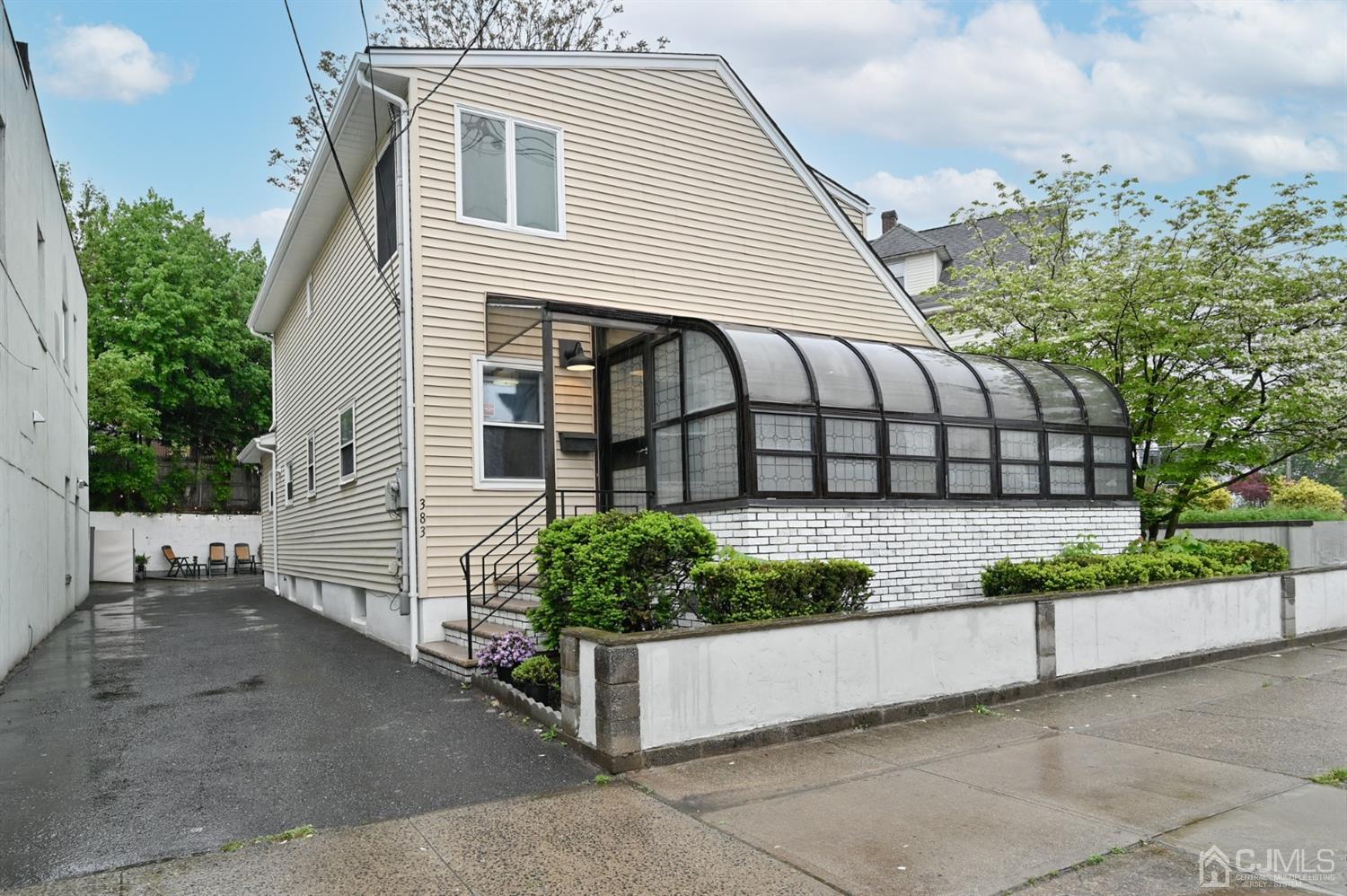 383 Paterson Avenue East Rutherford, NJ 07073 - Photo 19 of 21 a view of a white house with a yard and plants