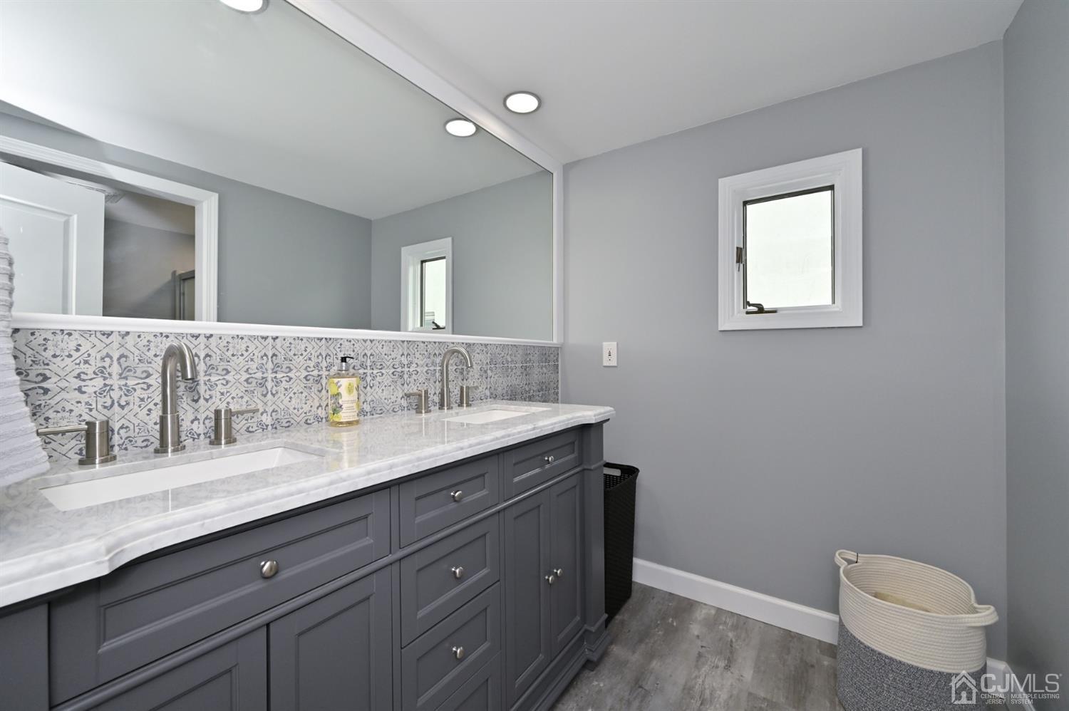 383 Paterson Avenue East Rutherford, NJ 07073 - Photo 6 of 21 a bathroom with a granite countertop sink a toilet and a mirror