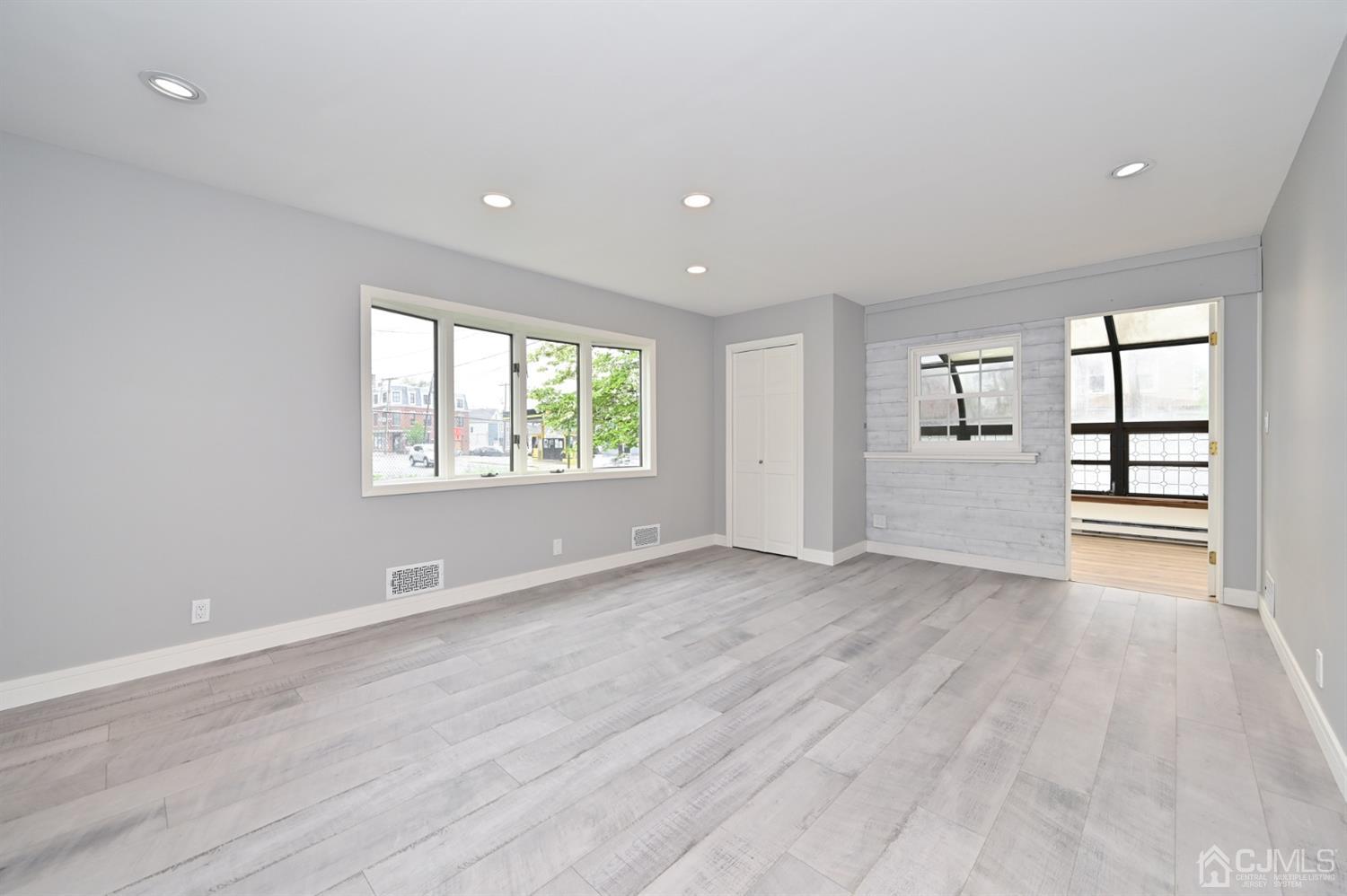 383 Paterson Avenue East Rutherford, NJ 07073 - Photo 7 of 21 wooden floor in an empty room with a window